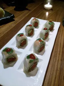 This Shima Roll, served at Sushi Roku, is artfully created with shrimp-wrapped spicy tuna, cilantro, avocado, and topped with Sriracha.  Photo by E'Louise Ondash